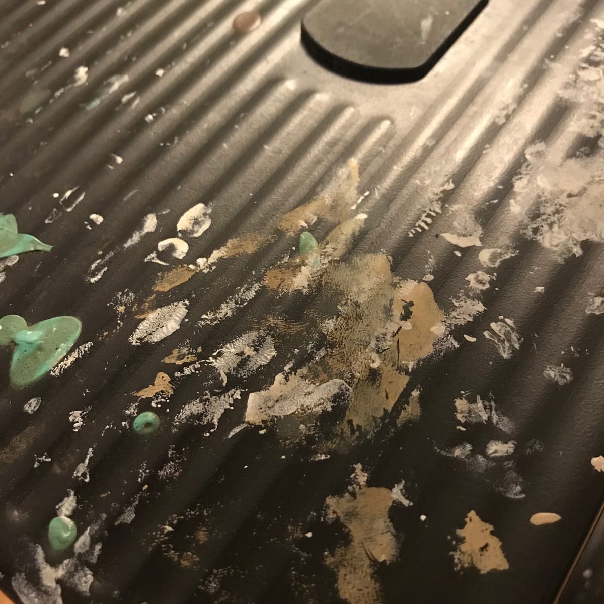 Ten colors of paint on a stepladder